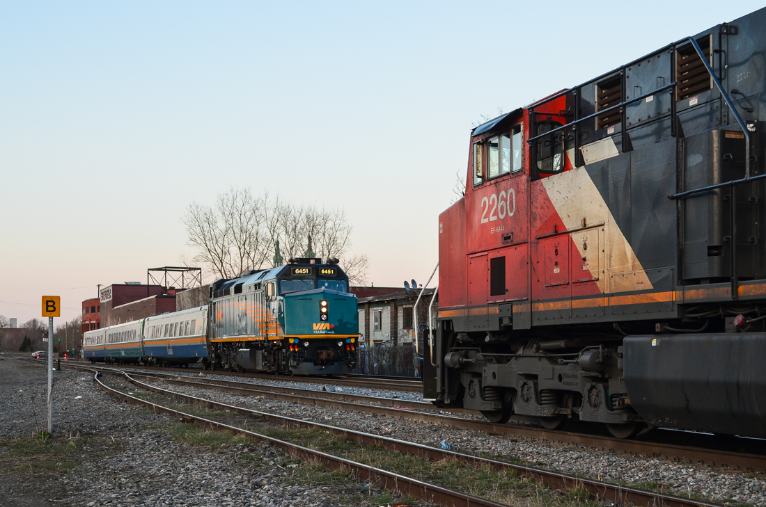 VIA 6451 leads a westbound past a stopped CN 308, which has CN 2260 and BCOL 4652 (out of sight). At this time CN 308 would regularly arrive here mid-afternoon and the train would be left crewless till early evening. A few months later, after the Megantic disaster, this practice would be discontinued. CN 308 now arrives in Montreal late at night, changes crews at Turcot west a few miles west of here and continues on its way. For more train photos, click here.