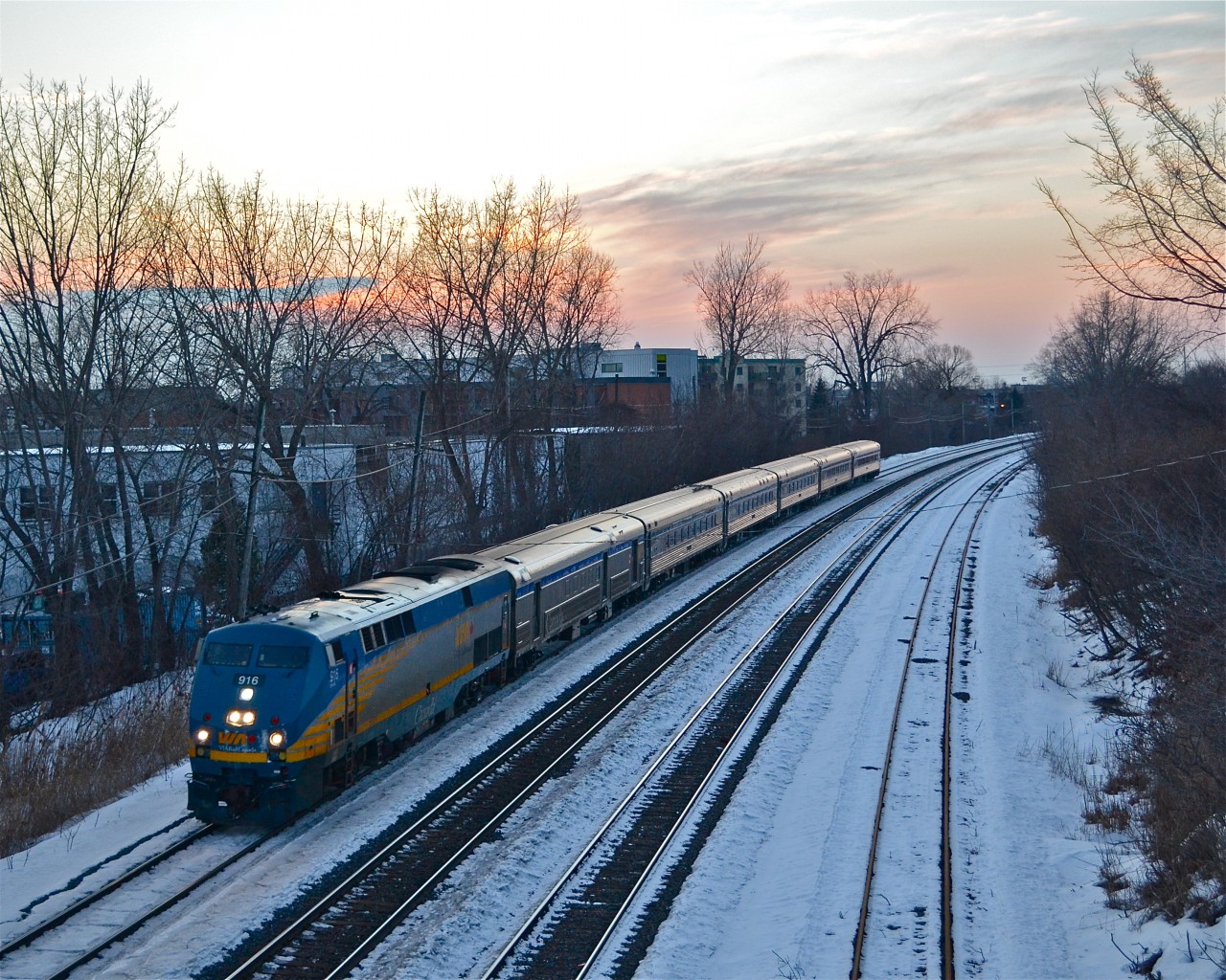 VIA 64 is nearly finished its long journey from Toronto (it makes eight stops between Union and Central Station) as it passes through the Ville St-Pierre neighbourhood of Montreal with VIA 916 leading 6 stainless steel cars. For more train photos, click here.