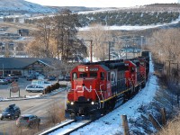 CN(WC)3027 is leading four units as they run alongside Kalamalka Rd in Coldstream and are heading east towards Lavington with a local freight.