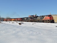 <b>A four Railway lashup.</b> CN 8853, NS 8034, CP 9500 & BNSF 4794 are heading east through the St-Henri neighbourhood of Montreal with a loaded oil train on a clear but cold day. The CN unit had been added to the lashup a few miles west when a new crew took over near Turcot West, prior to that the NS unit had been leading. For more train photos, check out http://www.flickr.com/photos/mtlwestrailfan/ 