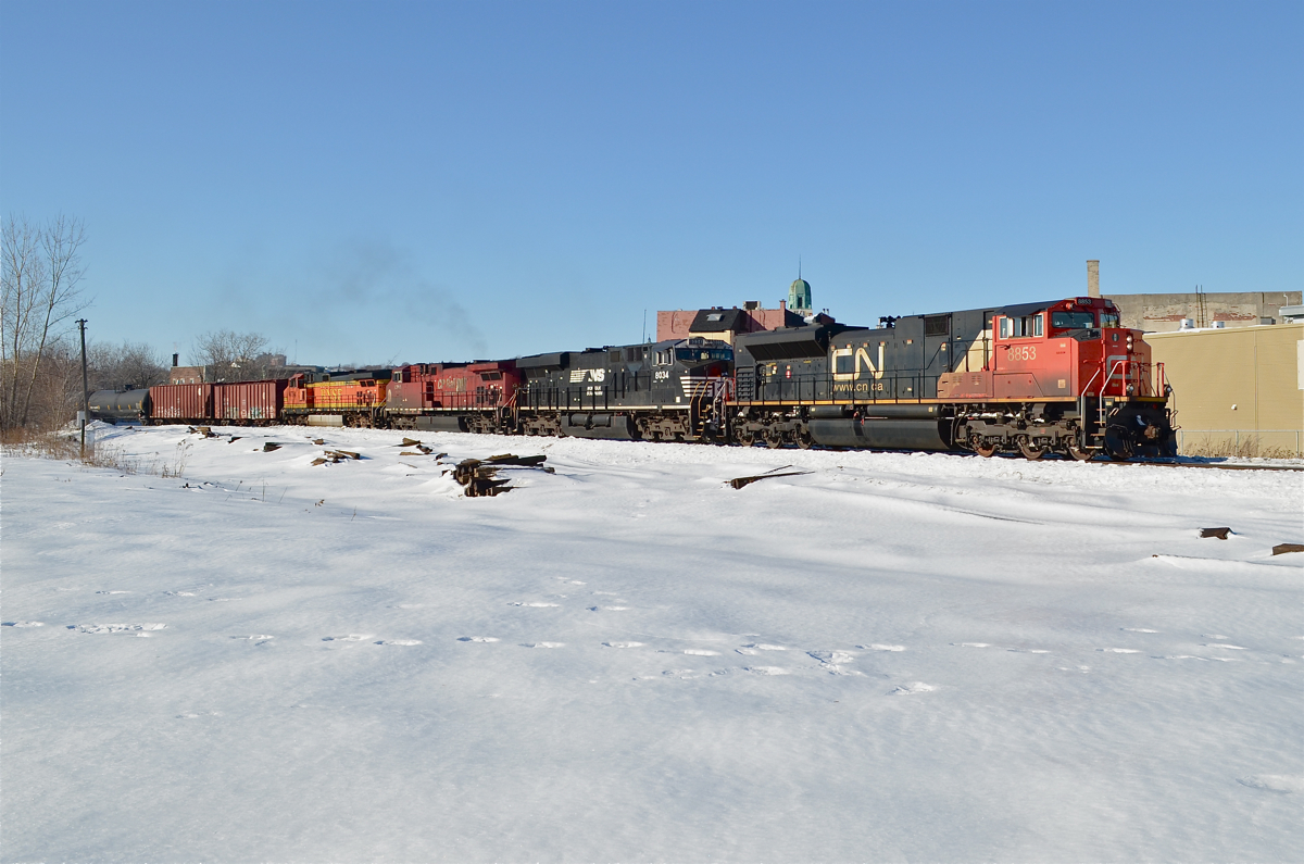 A four Railway lashup. CN 8853, NS 8034, CP 9500 & BNSF 4794 are heading east through the St-Henri neighbourhood of Montreal with a loaded oil train on a clear but cold day. The CN unit had been added to the lashup a few miles west when a new crew took over near Turcot West, prior to that the NS unit had been leading. For more train photos, check out http://www.flickr.com/photos/mtlwestrailfan/