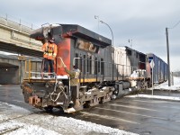 <i><b>Damaged Dash9!</b></i> CN 2684 (the DPU on CN 308 which derailed in Plaster Rock, New Brunswick on Jan. 7th 2014) is heading to CAD (Canadian Allied Diesel) in Lachine, Quebec for much needed repairs. One crewmember is boarding the engine after flagging the crossing. They are operating the two GP9's (CN 4102 & CN 7017) which are pushing the train westwards via beltpack. Of note is that this spur which only serves one customer now (CAD) was once CN's main line to the west till a line relocation in 1960. For more train photos, click <a href=http://www.flickr.com/photos/mtlwestrailfan/>here.</a>