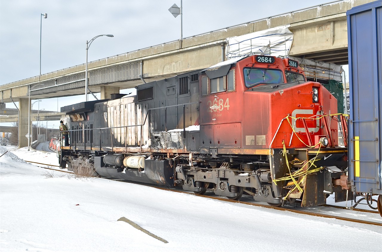 CN 2684 (the DPU on CN 308 which derailed in Plaster Rock, New Brunswick on Jan. 7th 2014) is heading to CAD (Canadian Allied Diesel) in Lachine, Quebec for much needed repairs. The crewmembers are operating the two GP9's (CN 4102 & CN 7017) which are pushing the train westwards via beltpack. Of note is that this spur which only serves one customer now (CAD) was once CN's main line to the west till a line relocation in 1960. For more train photos, click here.