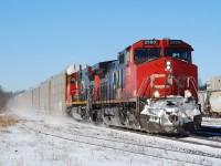 The detector at milepost 27 announced that it was -12, but the bright sun and lack of wind made for a nice day after the storm. CN 382 kicks up the fresh snow closely following VIA 72 eastbound on the Dundas Sub.