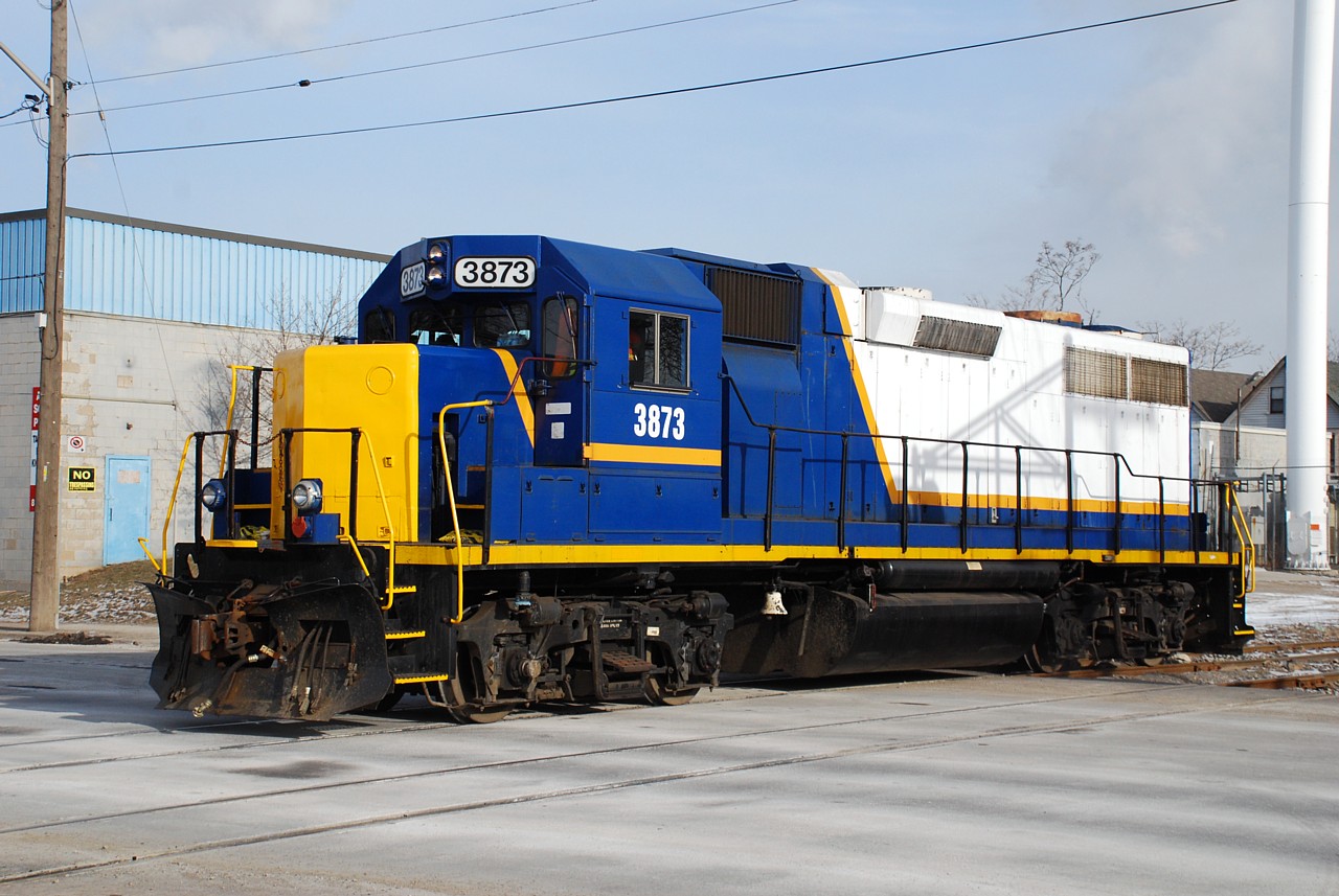 Former RaiLink 3873 shows off its latest logo-less look as the engine runs around its train just shy of milepost one on the North & Northwest Spur in the heart of grungy north end Hamilton.