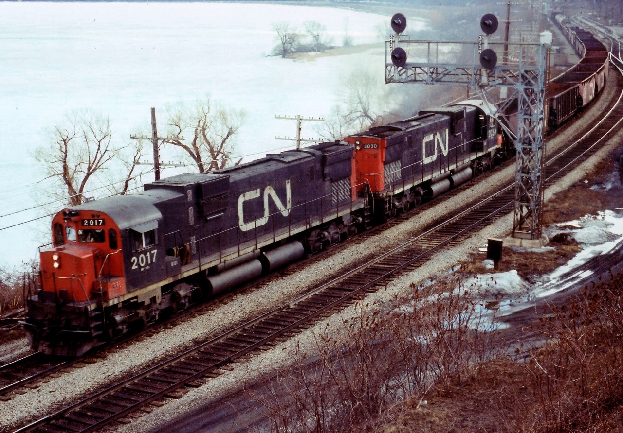 Its a little over a year since 'sdfourty's' capture of TH&B (#12998) at Hamilton Jct., and I wander over to almost the same location for a shot of CN heading eastward with what looks like mostly empties on a short train with CN MLW C-630M locos 2017 and 2030 gliding along, with a 35 cars and van 79572 bringing up the rear. I sure miss these beauties, all off the roster by 1996.