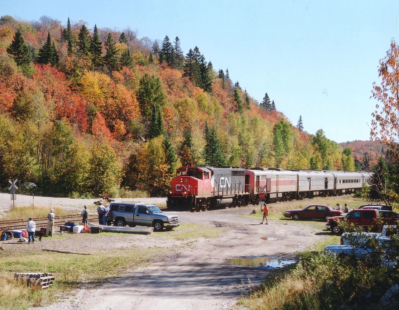 Here's an example of passenger service in recent years on the old ACR. A former GO Transit 704, now CN 9671 rolls into the hamlet of Frater on a pleasant fall morning, with several riders and their supplies ready to board. The railroad is their only link to the numerous cabins and camps along the way. One visit had me talking to a guy with a LOT of supplies, including 12 cases of beer, he explained he spent the whole summer in the wilderness and it was life the way he always wanted it. Off-season he lived in Michigan. Hopefully this service, killed by the federal government and due to be history before the snow melts, can be resuscitated to see at least a few more years. The road in to Frater, by the way, from Hwy 17, is not much short of a nightmare. Ruts and crevices, rocks, large stones and some of the way thru a dried creekbed, can still be navigated by a regular automobile, although s-l-o-w-l-y, unless you want to leave some parts behind. The Northern definition of a road is much different from the South.