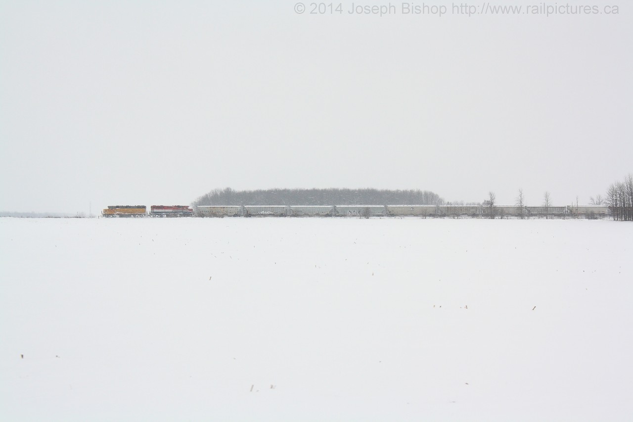 Pacing a Train While heading back to Stratford after meeting 581 near Mitchell Ontario, Rob slowed down to allow me to grab a couple of pace shots across an open field.
