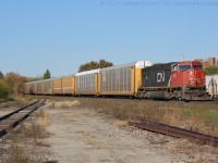 CN E276 rolls through Brantford with CN 5622 and a train of solid auto racks bound for Oakville.