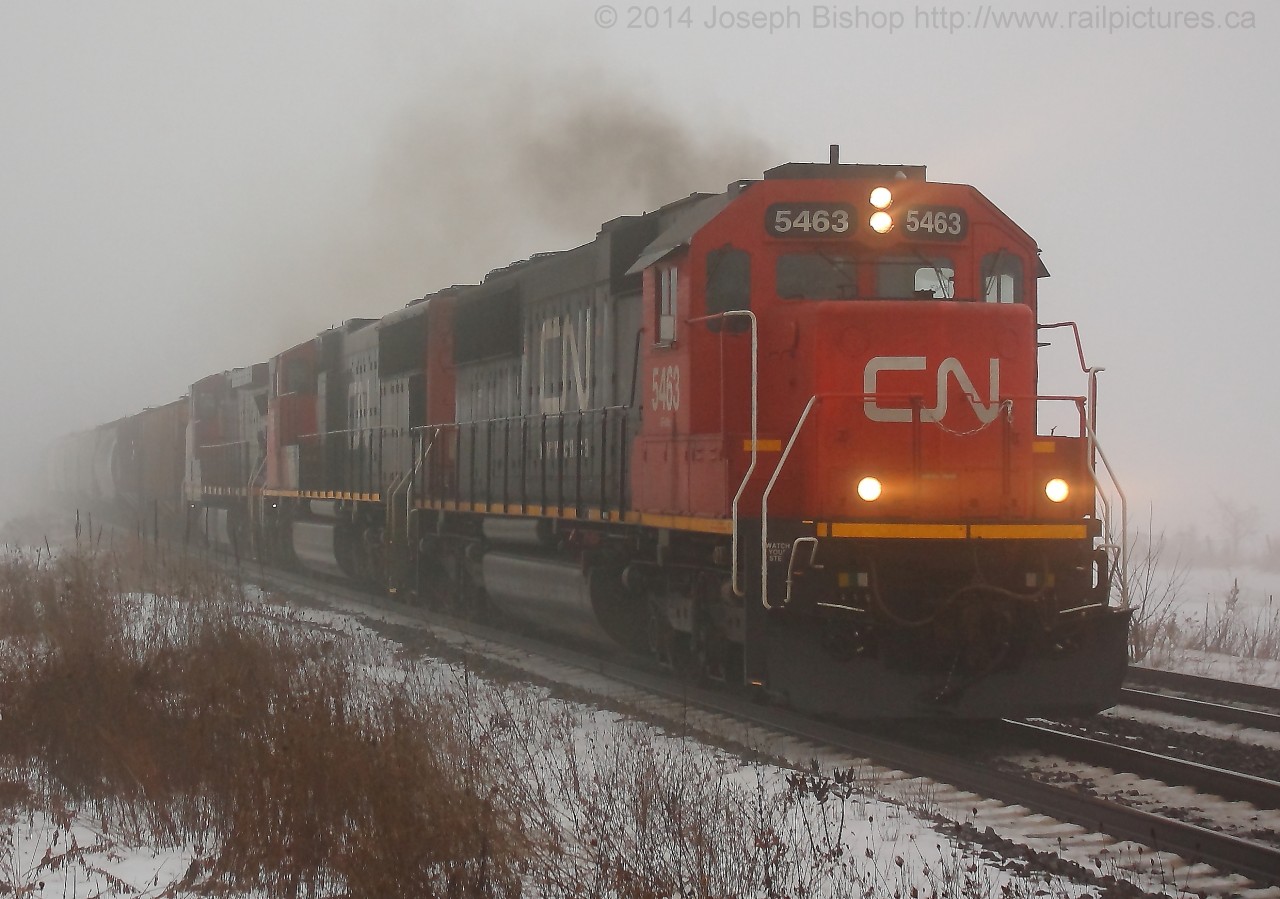 CN 394 blasts through Lynden with CN 5463 on the point amid the thick fog that blanketed most of Southern Ontario today due to rising temperatures and snow on the ground.  This isn't the most ideal angle at Lynden but the fog made it work!