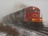 CN 394 blasts through Lynden with CN 5463 on the point amid the thick fog that blanketed most of Southern Ontario today due to rising temperatures and snow on the ground.  This isn't the most ideal angle at Lynden but the fog made it work!