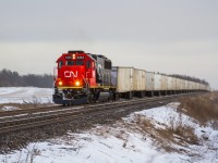 Typically traversing Southern Ontario under the cover of darkness, Triple Crown's 'Roadrailer' train # 144 from Detroit is on the final leg of the journey to Toronto as 5454 charges this hot train past Ash. With some uncertainty facing the future of the this road-to-rail service, I didn't hesitate to hop in the car and make the short trip out to the Halton Sub to catch this very late running eastbound. On a side note, thanks to Brendan for recommending this location.