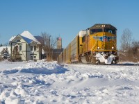 <b>Western Invader in Woodstock!</b>. A handsome Union Pacific (London-built) EMD SD70M guides train 276 through a snow-covered Woodstock with a healthy string of racks for Oakville. For the first time ever, I was able to shoot Union Pacific leading in Ontario!