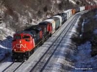 A brand new out of the paint shop bright CN SD70M-2 beast leads a westbound past mile 20 of the York subdivision.