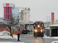 With OSR far behind in switching due to the recent ice storm, a weekend job was ordered to play catch up. Seen here, the crew finishes spotting up one lime car at Owens Corning while the brakeman manually protects York Rd. 