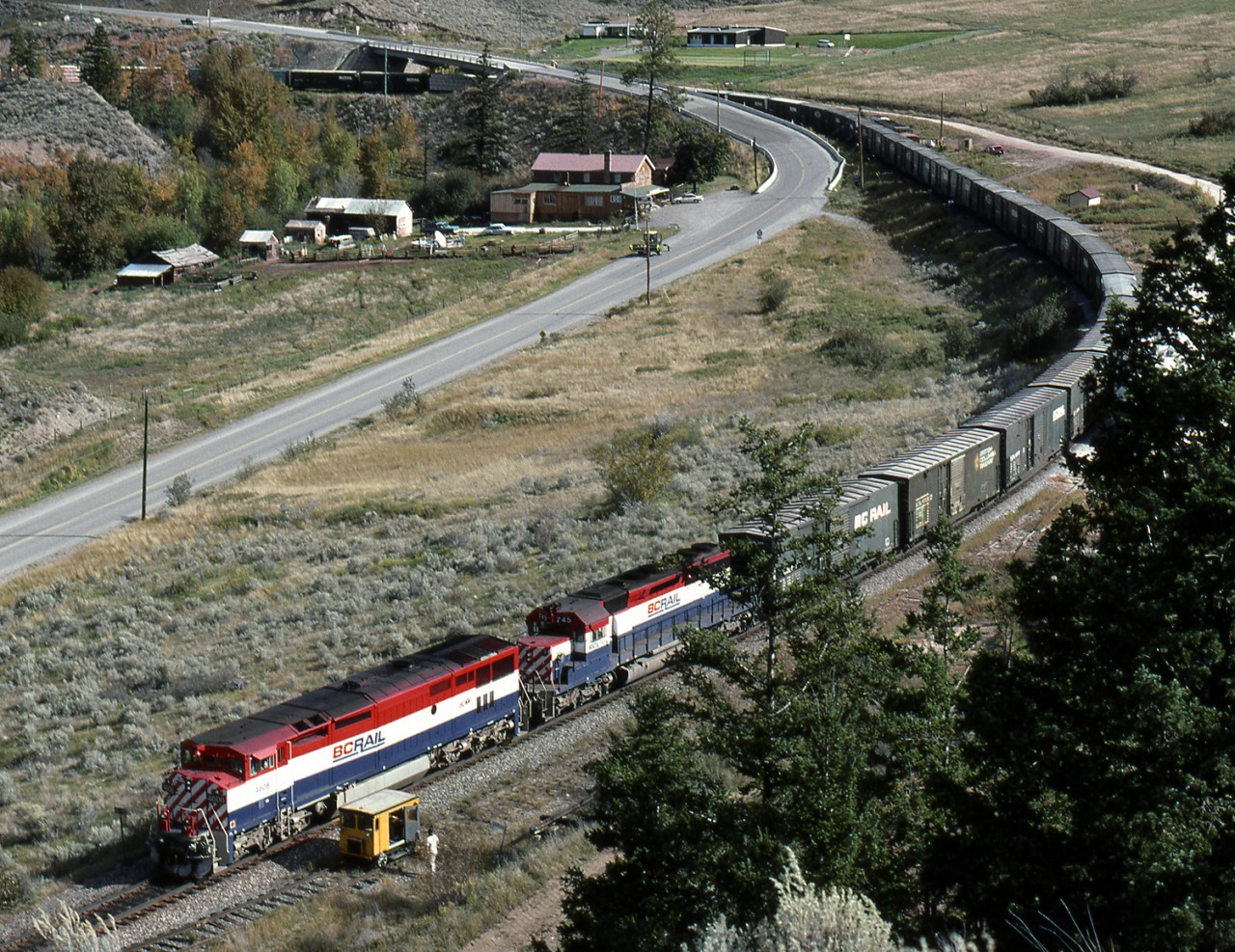 Southbound PV (Pace-Vancouver) freight navigates the loop at Pavilion as it descends toward the bottom of the Fraser Canyon at Lillooet. Note the track speeder in the clear