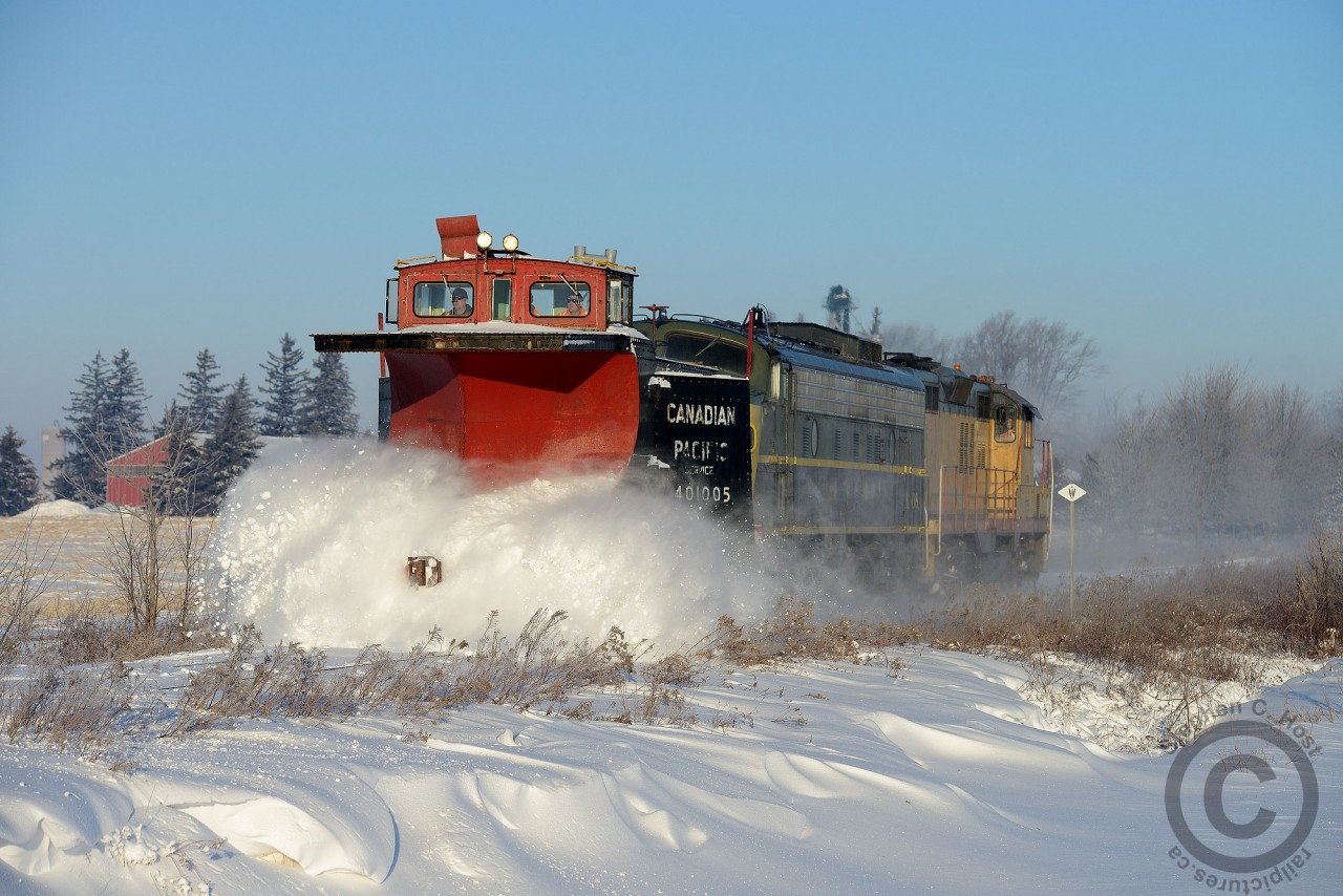 The flanges of 107 (!) year old CP 401005 (Built 1907, rebuilt 1927) do not quit on the approach to Mount Elgin on the Tillsonburg sub. After a few days of extreme cold, wind and snowstorms a considerable amount of precipitation had built up on the right of way. The day prior a train ran to Tillsonburg and pushed much of the snow asode. However, warm weather is forecast to arrive on Saturday, and a deep freeze on Sunday - the need to clear the right of way and flangeways of snow before it all turned to solid ice necessitated this plow run.