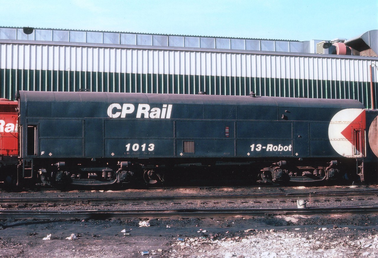 Although Robot Cars were manufactured using also coach and boxcar bodies, this is one example of only 11 Robots constructed using a locomotive shell.(#'s 1006-1016) The 1013 was the former CP 4457. This is a system in which a control car located usually just ahead of mid-train away from direct MU control can be controlled by the engineer in the lead consist. This was accomplished using radio signals. The 1013 housed radio equipment and data processing equipment to communicate between lead units and mid-train slaves. This particular unit went into operation Oct. 1972. By 1983, what is now known as Locotrol equipment was put into the noses of newer SD40-2s. The system was vital for running heavier trains thru the mountains of the West. I've no information as to when 1013 and the others of its kind left the CP roster, but I suspect they did not survive past 1990. In essence, this method of train control was the fore-runner of todays' DPU.
