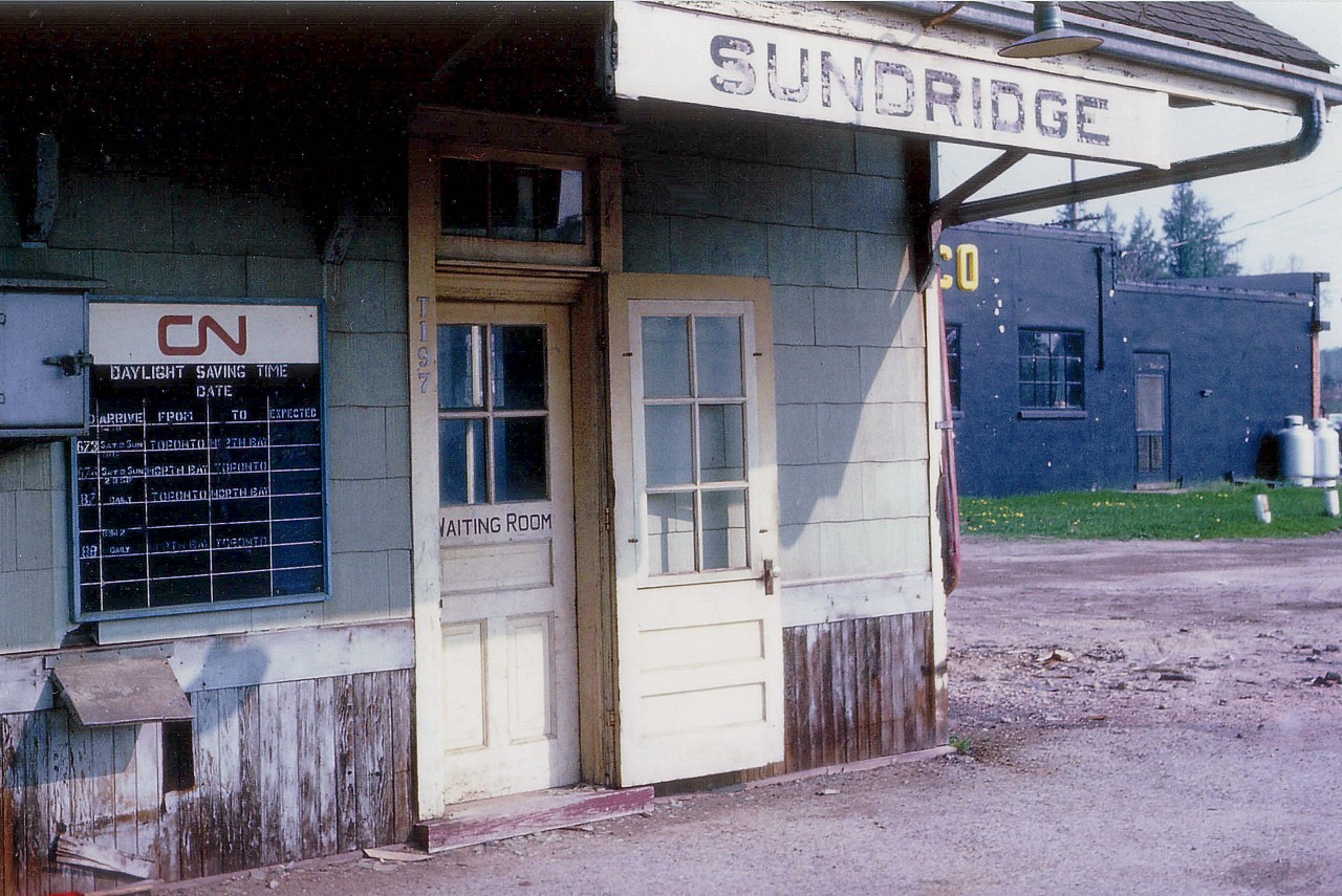 Strictly an image for nostalgia buffs, this old view at Sundridge, about 50 miles south of North Bay, represents a glimpse of an era long gone. Note the sorry condition of a structure and a way of travel that has for all intents and purposes, vanished. The old schedule board was a fixture at all stations; maybe not as nice as this one, but....... Storm windows clipped on the outer door, to be removed and replaced with screen once the weather improves...heck, it is only March. Old Sunoco garage out back. Yeah. This is a classy way to travel. No wonder there is no passenger service thru this community of barely 1,000 souls anymore. I don't recall when this building was demolished, but I suspect at least 30 years ago.