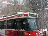 TTC streetcar 4246 on a 501 Queen run, heading eastbound as viewed from the Church Street stop, out of the falling snow.