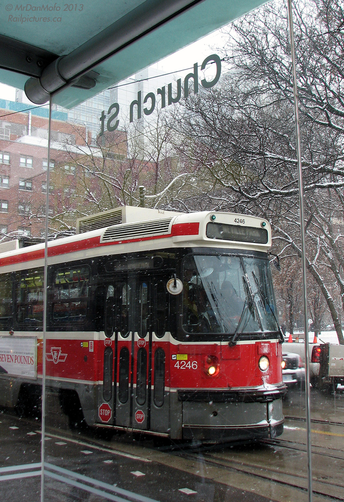 TTC streetcar 4246 on a 501 Queen run, heading eastbound as viewed from the Church Street stop, out of the falling snow.