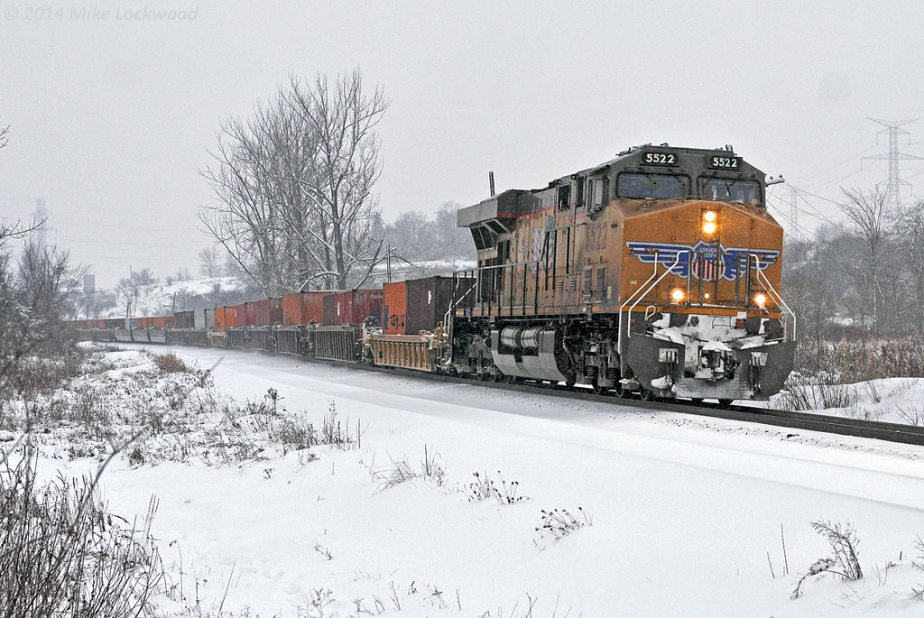 UP 5522 leads CP train 118 past the Cherrywood siding as the snow begins to fall. With the UP 5312 in DPU mode on the rear end, this train has an all Union Pacific set of power. Ghosts of the UP ALCO FA's that CP leased in the early 1960's. 1607hrs.
