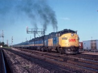 The "dinner hour" VIA #75 is seen here accelerating away from the old Burlington West station with the typical long train of the day. Power is VIA 6529, 6865 and 6634. Track on the left is the beginning of Halton Sub.