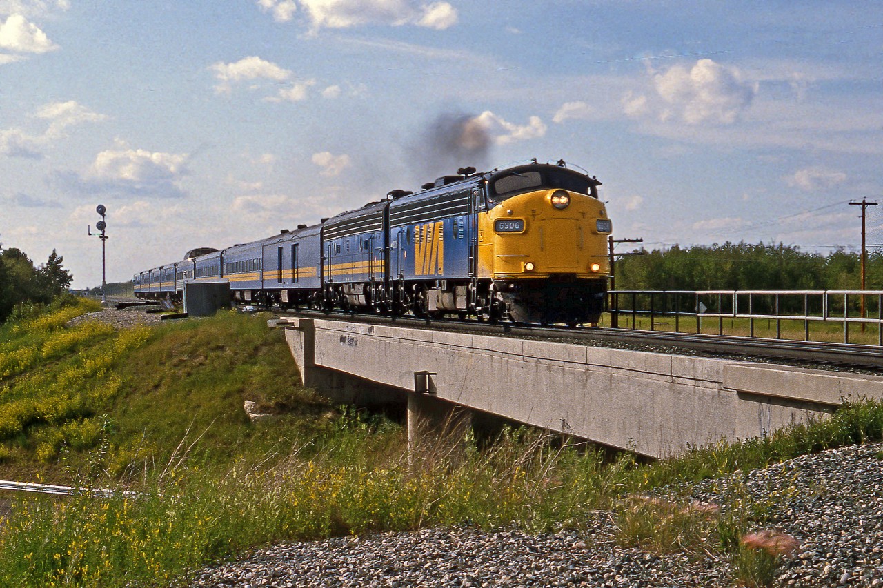 Years before the second track was added between Ardrossan and Uncas Via's eastbound Supercontinental headed by FP9A #6306 crosses the baseline road bridge at Ardrossan.
