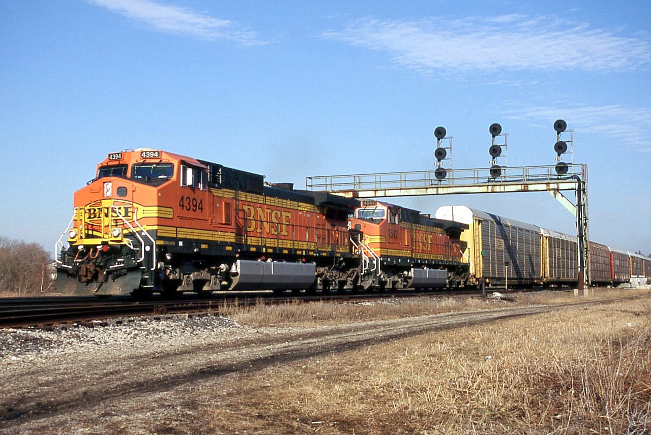 CN 393 with BNSF 4394 and 4542 pass under the signal bridge at Paris Junction.