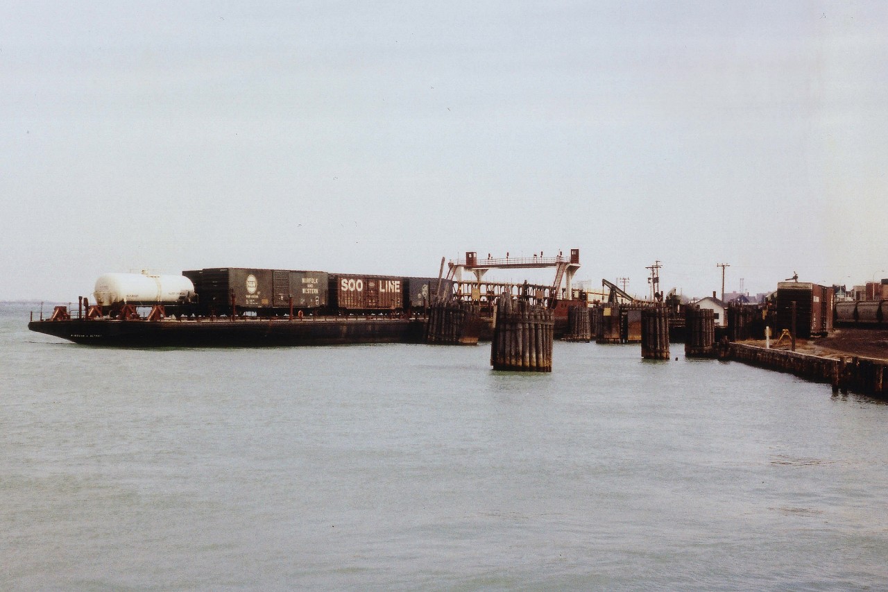 I am not sure of this photo and am asking for viewer input. Back in 1977 when I shot this scene, I only wrote in my notebook "N&W Slip" referring to the fact I thought this the old Pere Marquette/Wabash/N&W rail ferry slip. Looking at the provided map, I can only find "CN levelling ramps" and I know CN went out of this business here long before this photo was taken. So, do we have an N&W rail barge on the Detroit River which connected with the USA at this location?  Interesting piece of railroad history non-the-less.