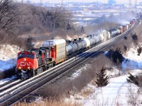 On a very windy winter day, CN X301 rounds the bend at Humber, otherwise known as "Knuckle Alley".