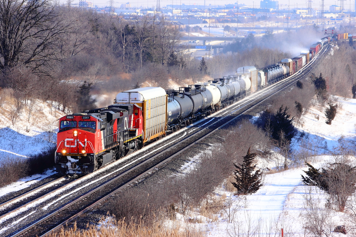 On a very windy winter day, CN 393 rounds the bend at Humber, otherwise known as "Knuckle Alley".