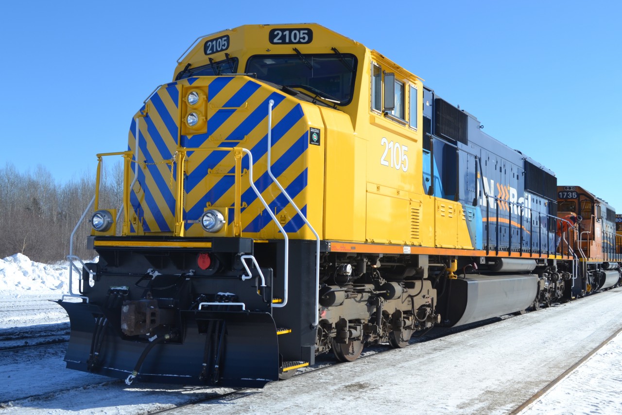 She's back! SD75I #2105 rolls past the camera trailing 5th out on the 214 lash up as the crew backs up the power to hook up to the tonnage.  2105 returned 2 weeks ago after being side lined for 12 months after a run in with a log truck December 2012.