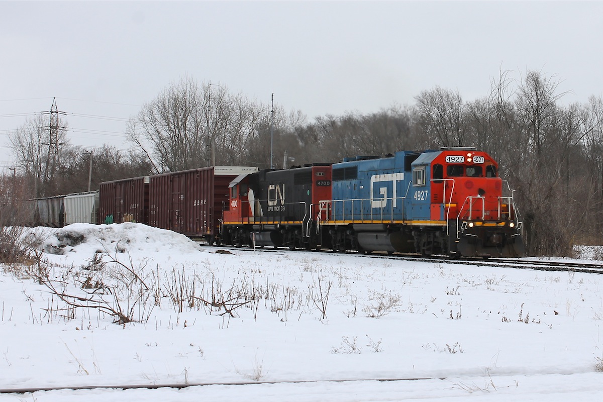 A special visitor has been hanging around the last few days... in the form of a GTW geep! Unfortunately due to my work schedule and other commitments I haven't been trackside enough to catch him but today was my chance! Not often does foreign power end up on local trains but this is proof that it does, and lucky of all of us it was leading too! 

Here we see GT 4927 and CN 4700 accelerate across the former CSX diamond at Chatham East, what a sound!