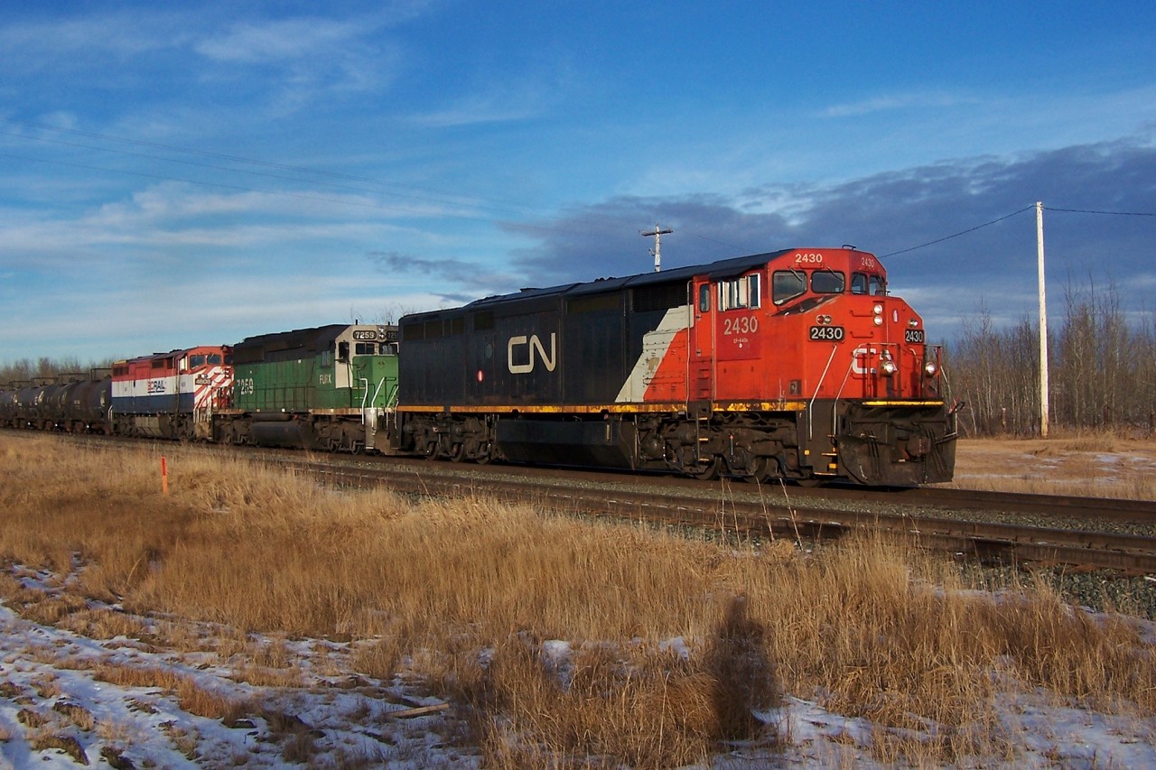 CN Dash 8-40CM 2430, FURX SD40-2 7259, and BCOL Dash 8-40CMu 4608 travel eastbound through Uncas.