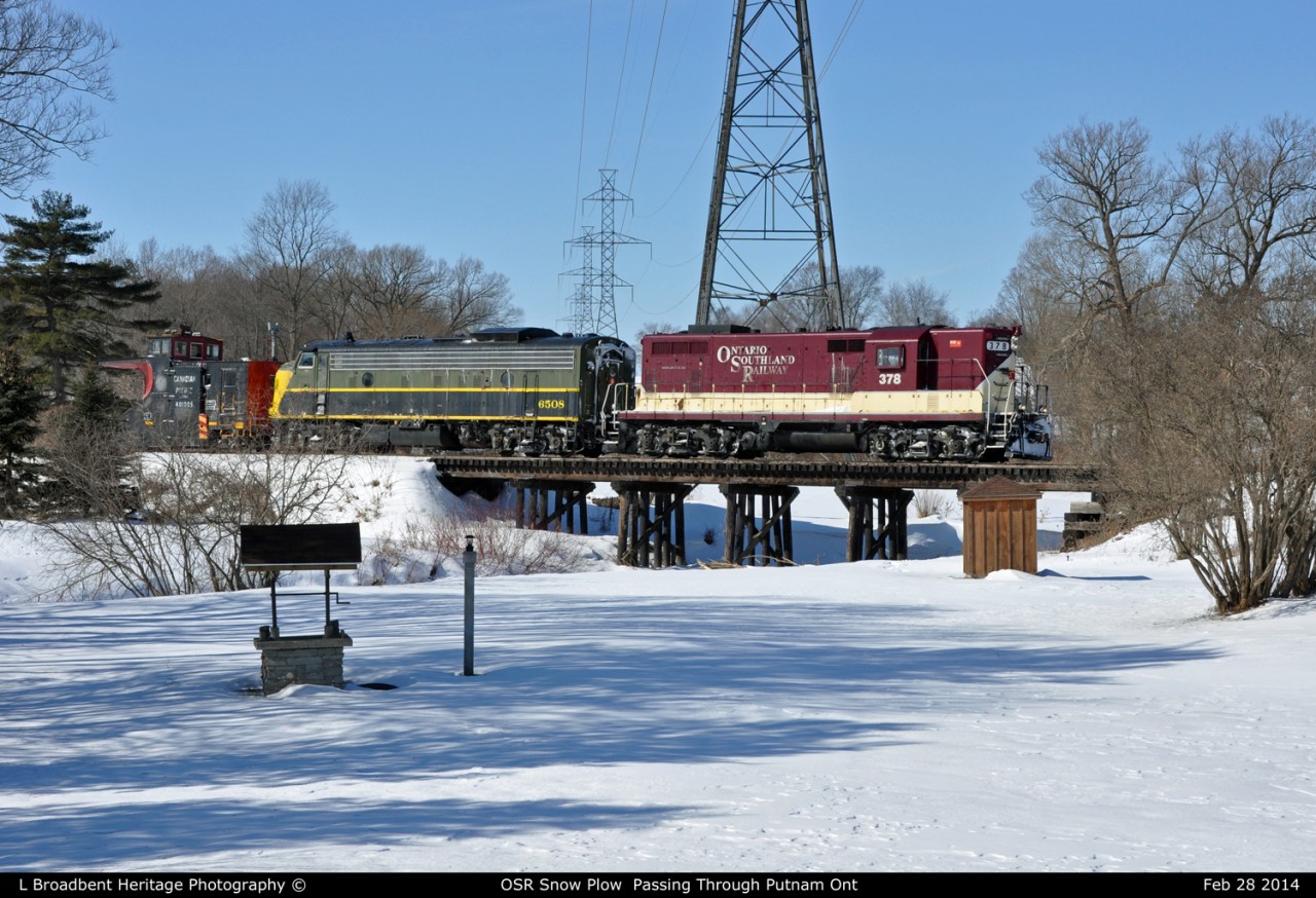 What must be a record year for Plow Trains the OSR Plow Extra crosses the Wooden Bridge By the Snow Covered Tamarack Ridge Golf Course