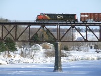 CN 310 passes over the Nicolet river with 8831 in mid train.