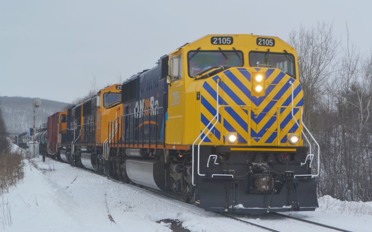 ON SD75I 2105 shows off her new look on a successful run on Freight 214 from Englehart after a year out of service due to hitting a Log truck on the Kirkland Lake Subdivision last December. The locomotive features experimental reflective striping on the new nose section in hopes of preventing future crossing accidents, as well as dawning the new "Arrow" scheme yellow.