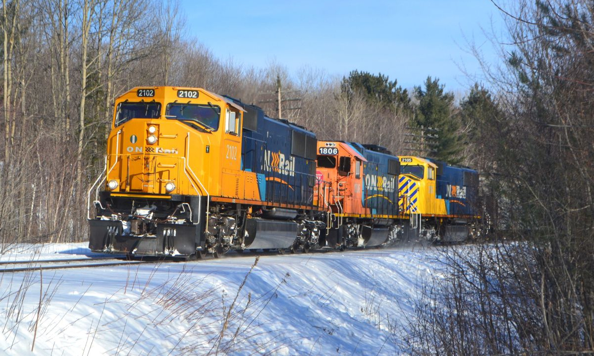 ON 2102 chrages by with freight 214 as they arrive in North Bay February 13th.