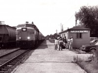 Of course typical government cutbacks have managed to eradicate this once common scene forever, but back on a warm day in 1987 here is proof people rode the train; even from a scaled down facility such as this. The last time I visited this little stop before the passenger was discontinued; the waiting room had no phone, no heat,(or A/C) no timetable and filthy graffiti covered walls and one soiled bench to make the traveler feel at home. In order to find out how late the train would be,a note pinned on the wall suggested the rider check with the travel agency downtown...but you had better have your own phone..... It is a wonder some passenger routes hung on as long as they did. This image is of the Montreal portion of the 'Canadian' with VIA 6767 sole power. There isn't even any track east of Mattawa any more............