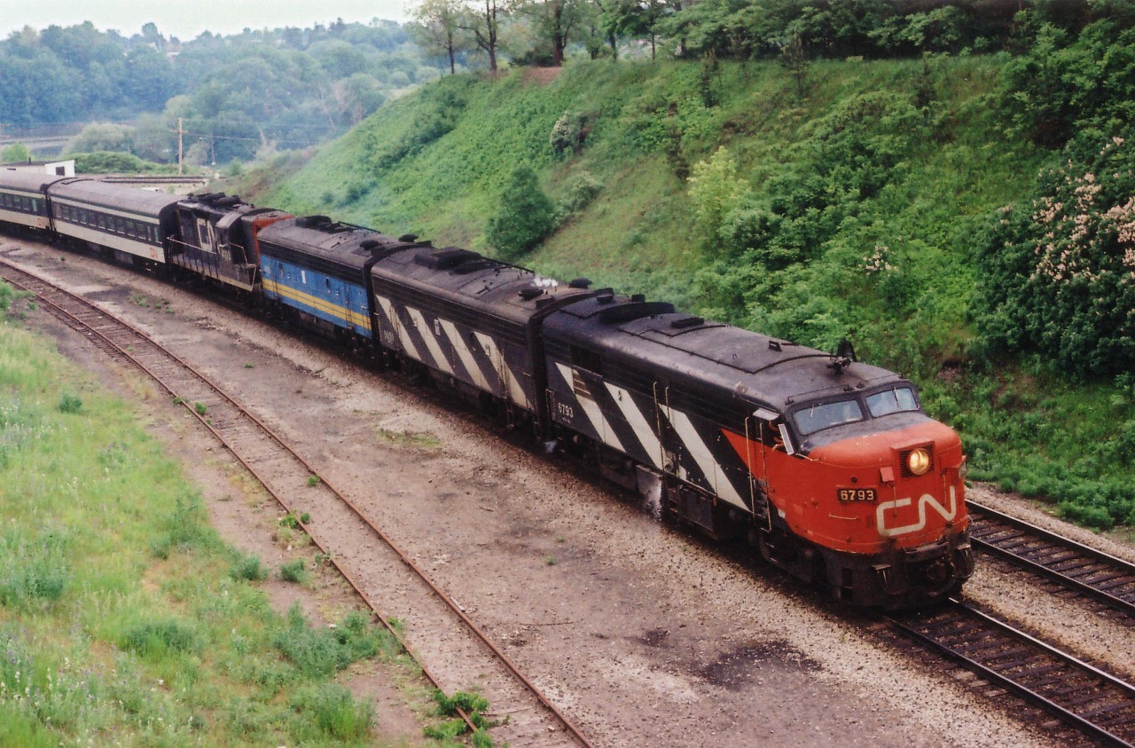 Only a few months "pre-VIA", this late day #75, always running with something of interest, sweeps around the curve past Bayview Jct on its way west with CN 6793, 6618, 'VIA' 6631 and CN 4103. The close track, now long gone, was once used for steam engine helpers for those trains climbing the long Dundas grade west. In later years, MoW was stored there.