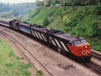 Only a few months "pre-VIA", this late day #75, always running with something of interest, sweeps around the curve past Bayview Jct on its way west with CN 6793, 6618, 'VIA' 6631 and CN 4103. The close track, now long gone, was once used for steam engine helpers for those trains climbing the long Dundas grade west. In later years, MoW was stored there.
