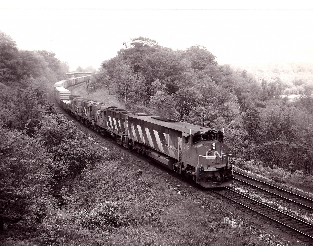 The big boxy Bombardier product, CN 2112, certainly dwarfs its companions in this image of a westbound train approaching the Railfan's Walkbridge down near Bayview Jct. Trailing are CN 3726,3125, both RS-18s, as well as CN 4248, a GP9. All are now off the roster. The BBD was sold to National Railway Equipment by 1998.