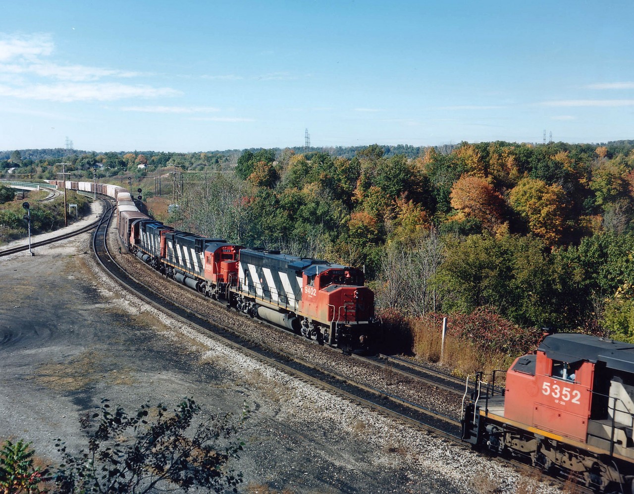 Longer trains and fewer of them results in meets being rather infrequent compared to days past. Here we see westbound CN 5352 about to climb the long grade west of Bayview as an eastbound, with CN 9402, 2039 and 20xx, complete with white "Extra" flags, approaches the Jct at Bayview on a nice fall afternoon. Image shot with the ol' Speed Graphic and colour sheet film.