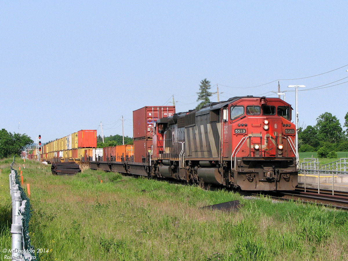 Hotshot transcontinental intermodal? Time-sensitive fast freight from the states? Nawww, it's just ol' land barge CN 384 with its normal business at the front and party in the back: a huge cut of intermodal right behind the power for Brampton Intermodal Terminal, followed by general manifest freight on the rear for Mac Yard. CN SD60F 5513 and SD40-2W 5351 are on point as the train heads through Mount Pleasant GO station, stretched out along the roller coaster track profile past the new and old signals at Norval.