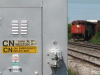 <b>The Signal Bungalow Tells All</b>. Making their way 'round the bend to head down to CP Lambton Yard, after departing CN's Malport Yard, a pair of GP40-2LW units inch train 577 to the crossing at Torbram Road, Mile 16.17 of the CN Weston Sub.