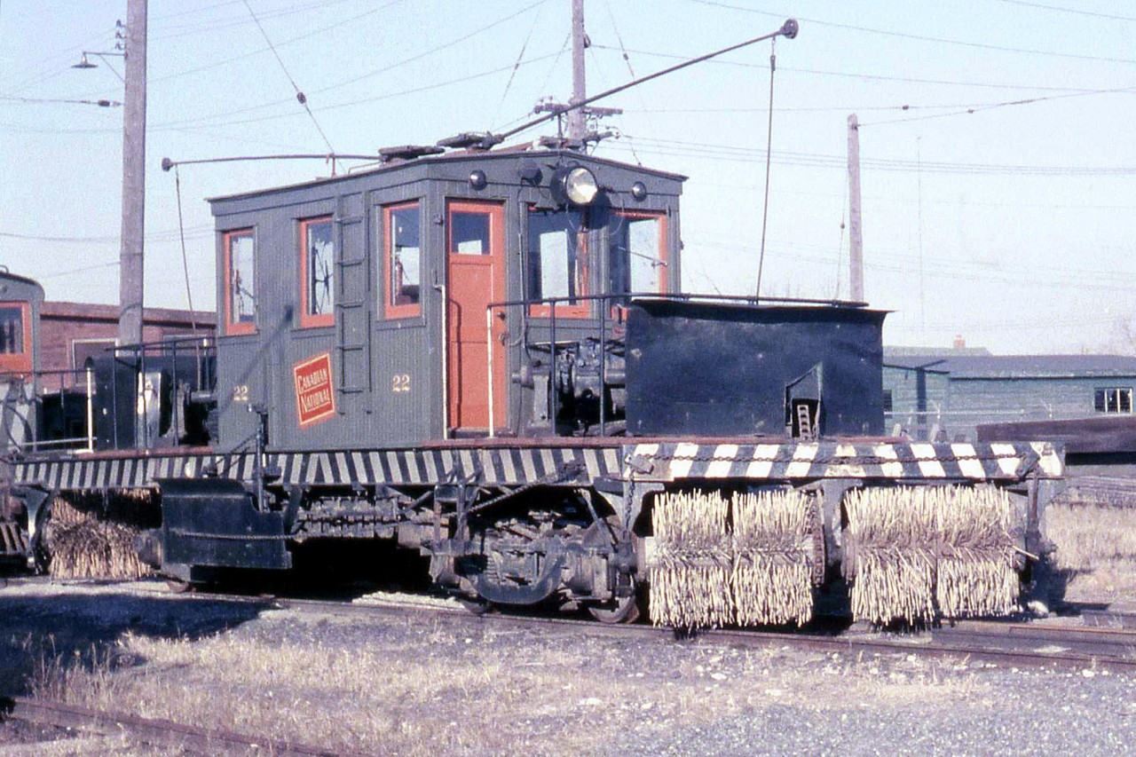 Canadian National electric sweeper car 22, assigned the Oshawa Railway, rests at OR's shops off Hillcroft Street. This car was originally built for the Niagara, St. Catharines & Toronto Railway, another one of Canadian National Electric Railway's lines (CNER), and reassigned to the Oshawa Railway when the NStC&T ended electric operations. Note the chain-driven sweeper, powered by an electric motor mounted just above behind the black housing.