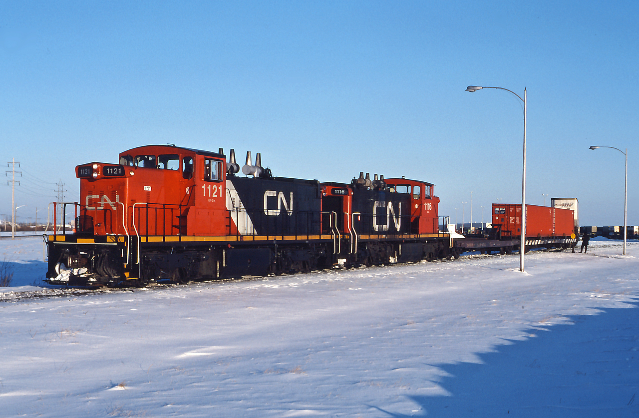 CN 1121 and CN 1116 switch at Winnipeg Intermodal Terminal on a frigid December afternoon.