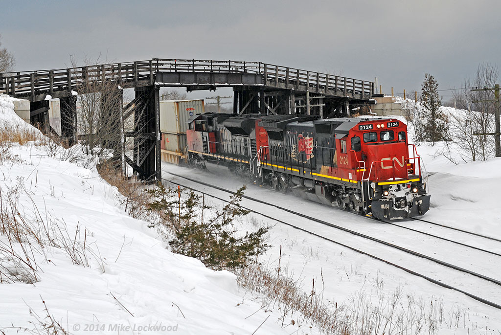 With 150 OOCL cans (as well as other carriers) behind them, CN 2124 and 8019 lead 149's train out from under the Lakeshore Road bridge at Lovekin. No, I never tire of shooting here. 1431hrs.