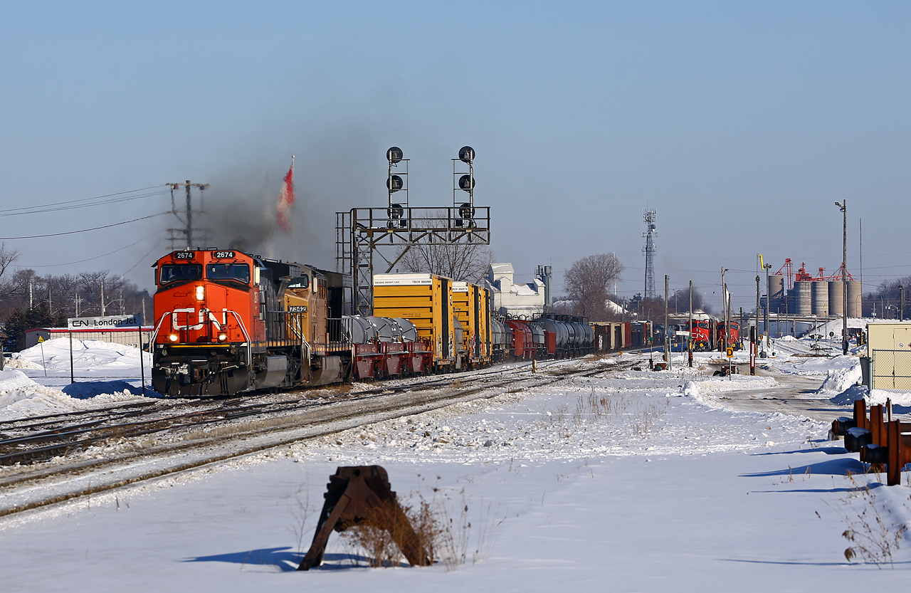 Perhaps the most-photographed train in southwestern Ontario yesterday, CN 331 leads a parade of four westbounds on the west end of the Dundas sub amid a busy afternoon. After catching yellows into town, the crew puts the hammer down to make a run for the grade up to Lobo from the Thames river bridge. Right behind this guy was X301, then 393 (in the yard in the distance), and 397; there were no fewer than 9 freights through town in less than 3 hours.  Seeing the AC6000 was pretty neat, as I was finally able to catch some FPON. CN 393 was stopped to swap power with 434 when his lead unit quit loading; 397 then stopped to set off BCOL 4651 for 434's train.